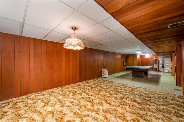 recreation room featuring gas water heater, wood walls, and billiards