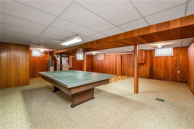 playroom featuring a drop ceiling and wooden walls