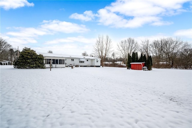 yard covered in snow featuring an outdoor structure