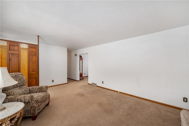 sitting room featuring light colored carpet