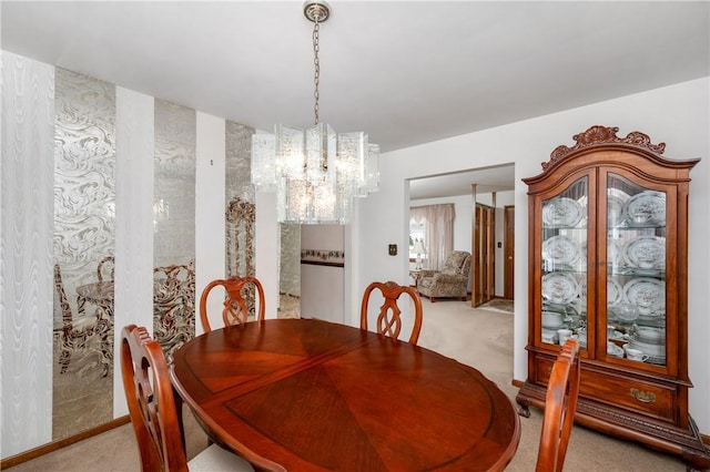 carpeted dining room featuring a chandelier