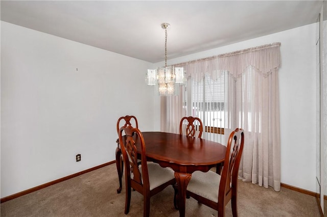 dining room featuring carpet flooring and a notable chandelier