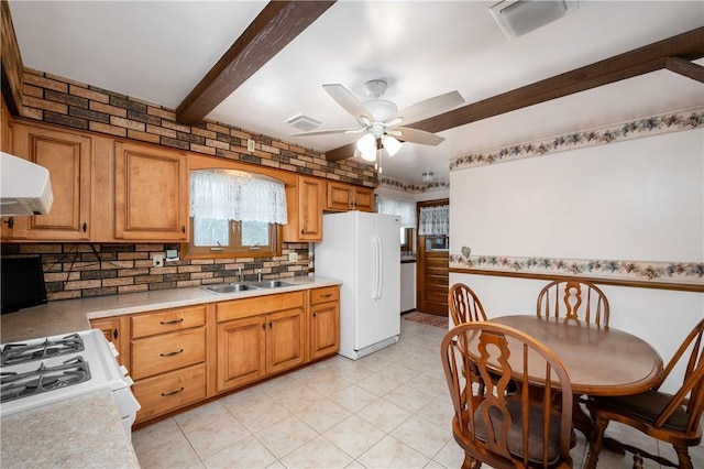 kitchen with backsplash, white appliances, ceiling fan, sink, and beam ceiling