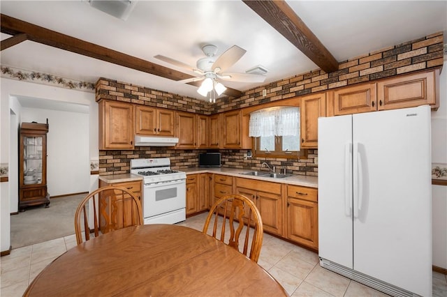 kitchen with white appliances, ceiling fan, sink, beam ceiling, and light tile patterned floors