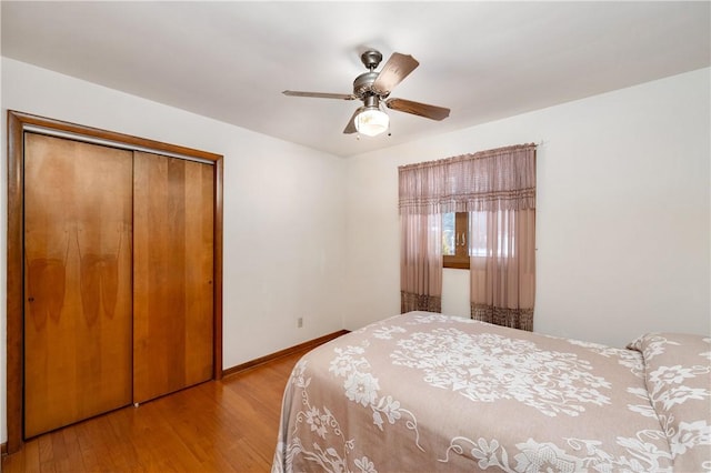 bedroom with ceiling fan, a closet, and light hardwood / wood-style flooring