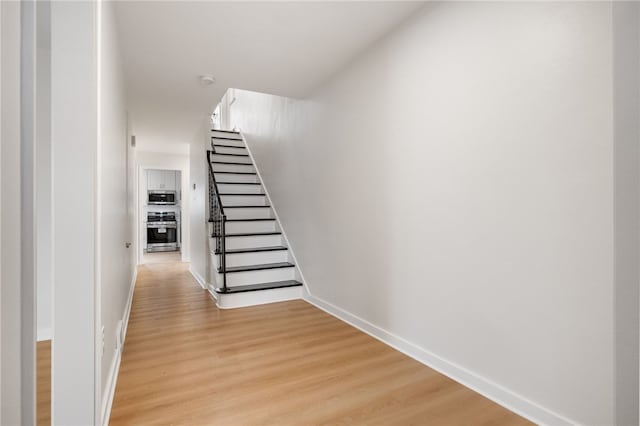 staircase featuring wood-type flooring