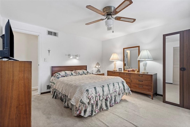 bedroom with ceiling fan and light carpet