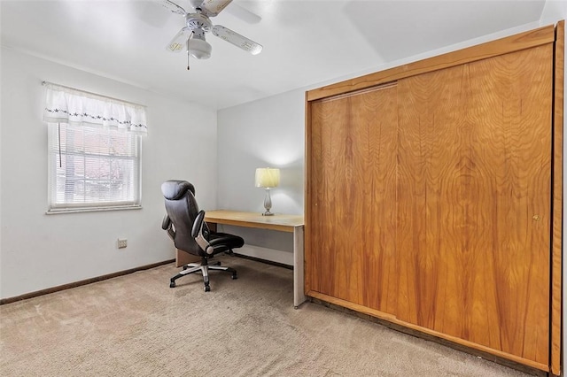 carpeted office space featuring ceiling fan