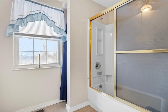 bathroom with tile patterned flooring and shower / bath combination with glass door