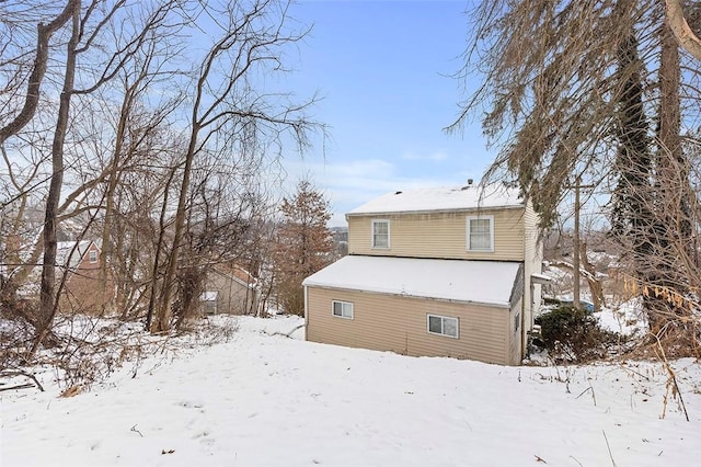 view of snow covered rear of property