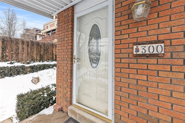 view of snow covered property entrance