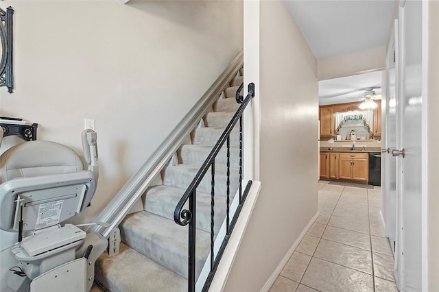 staircase featuring tile patterned flooring and ceiling fan