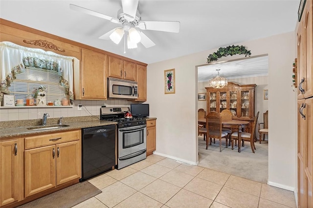 kitchen with light carpet, ceiling fan with notable chandelier, sink, decorative backsplash, and appliances with stainless steel finishes