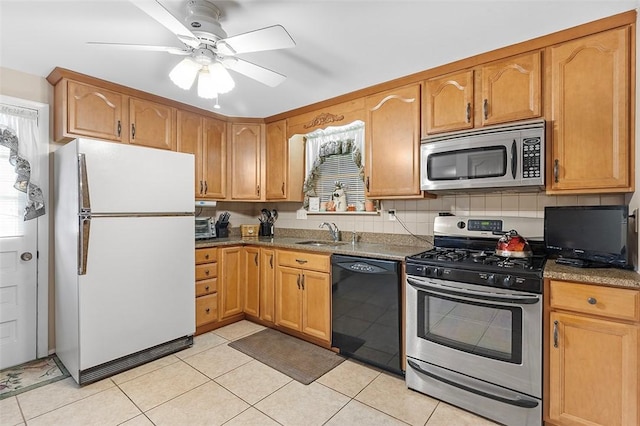 kitchen featuring sink, ceiling fan, light tile patterned floors, stone countertops, and stainless steel appliances