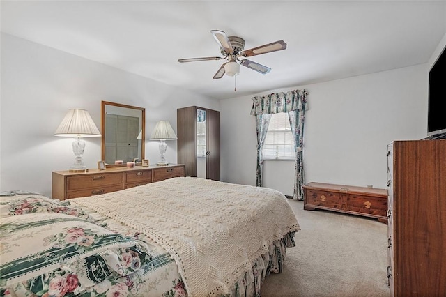 bedroom with ceiling fan and light carpet