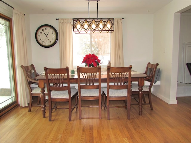 dining area with a healthy amount of sunlight and light hardwood / wood-style flooring