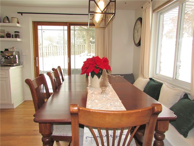 dining room with light hardwood / wood-style floors and a chandelier