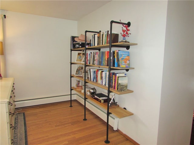 hallway featuring hardwood / wood-style flooring and a baseboard radiator