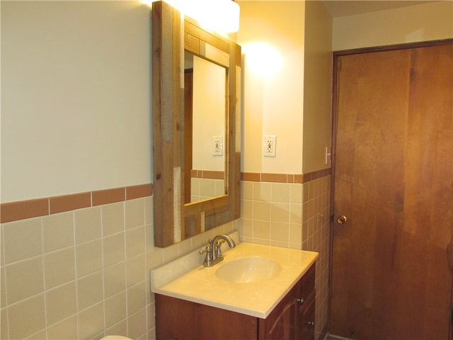 bathroom with tile walls and vanity