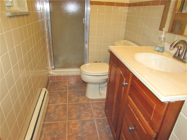 bathroom with toilet, vanity, tile walls, baseboard heating, and a shower with door