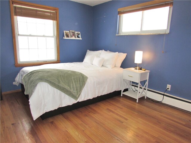 bedroom with dark hardwood / wood-style floors