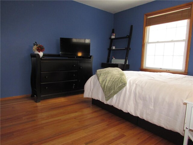 bedroom with hardwood / wood-style floors