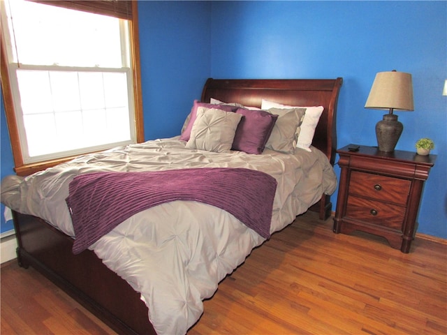 bedroom with hardwood / wood-style floors