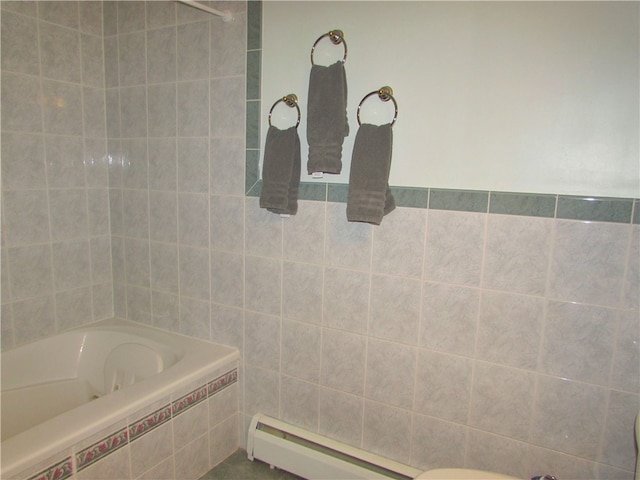 bathroom featuring a bathtub, tile walls, and a baseboard heating unit