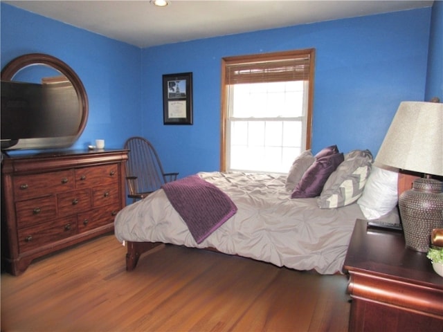 bedroom with recessed lighting and wood finished floors