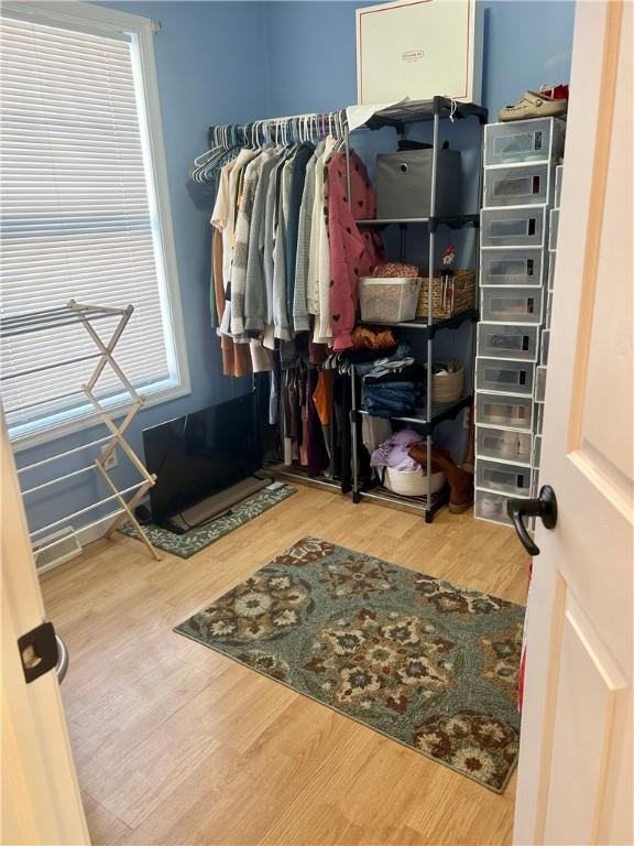 walk in closet featuring hardwood / wood-style flooring