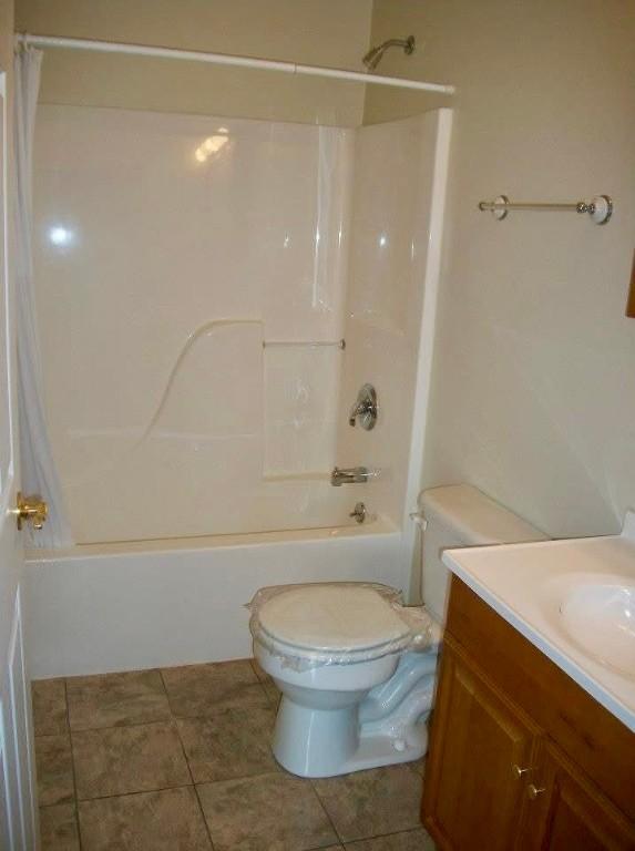 full bathroom with tile patterned flooring, vanity, toilet, and shower / washtub combination