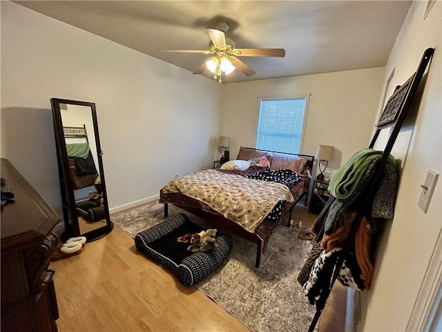 bedroom with ceiling fan and wood-type flooring