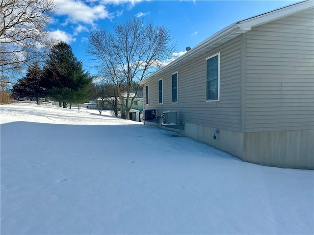 yard covered in snow with cooling unit