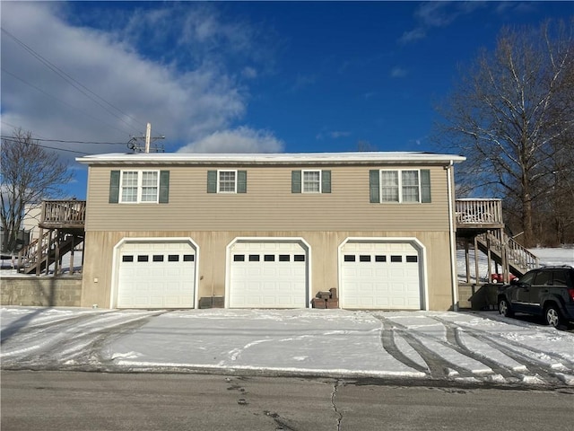 view of front of property with a wooden deck and a garage