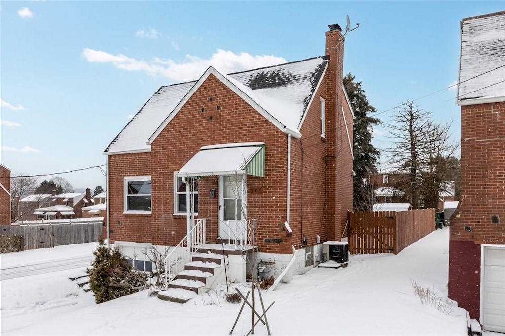 bungalow-style house featuring cooling unit