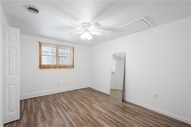 spare room featuring hardwood / wood-style floors and ceiling fan