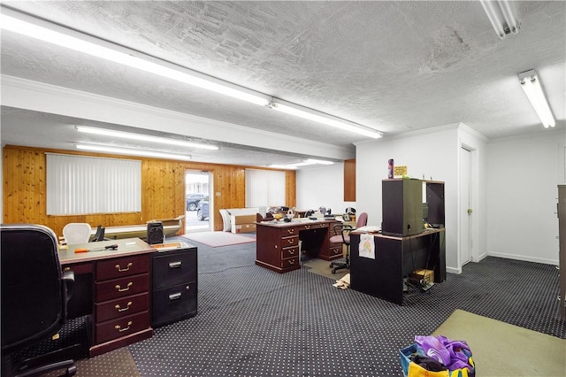 office with wood walls, ornamental molding, a textured ceiling, and dark colored carpet