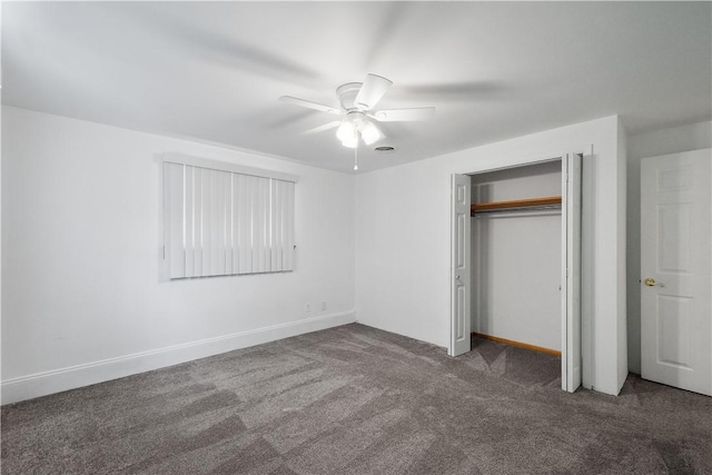 unfurnished bedroom with a closet, dark carpet, and ceiling fan