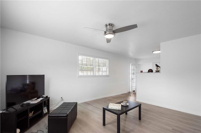 living room with ceiling fan and wood-type flooring