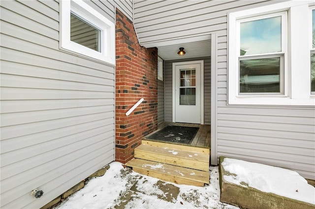 view of snow covered property entrance