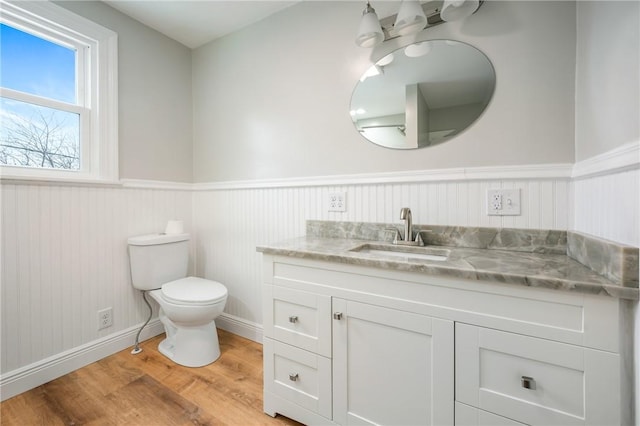 3134 Main St, West Middlesex Boro, PA 16159 - bathroom featuring a wainscoted wall, toilet, baseboards, wood finished floors, and vanity