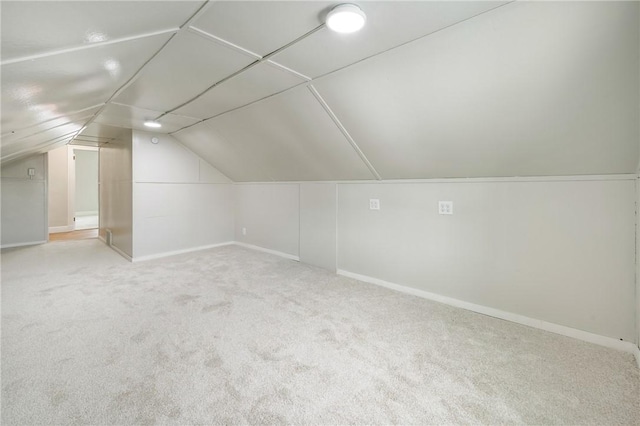 bonus room featuring light colored carpet and lofted ceiling