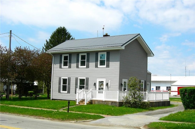 3134 Main St, West Middlesex Boro, PA 16159 - colonial-style house with a chimney, a front lawn, metal roof, and a deck