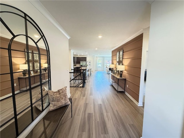 hall with hardwood / wood-style flooring and ornamental molding