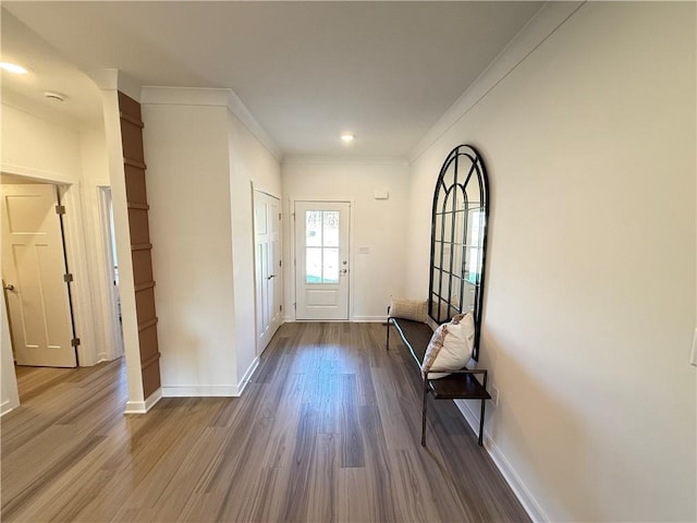 entryway with hardwood / wood-style flooring and crown molding