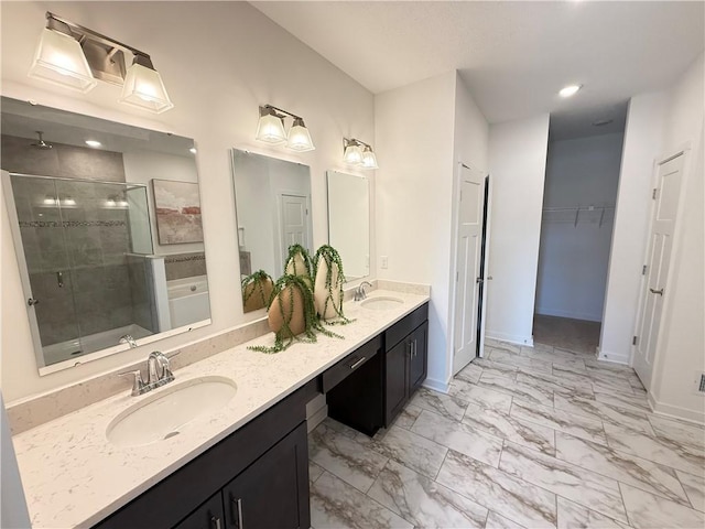 bathroom featuring vanity and an enclosed shower