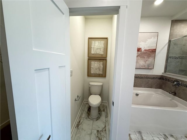 bathroom featuring a tub to relax in and toilet