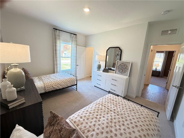 bedroom featuring light colored carpet