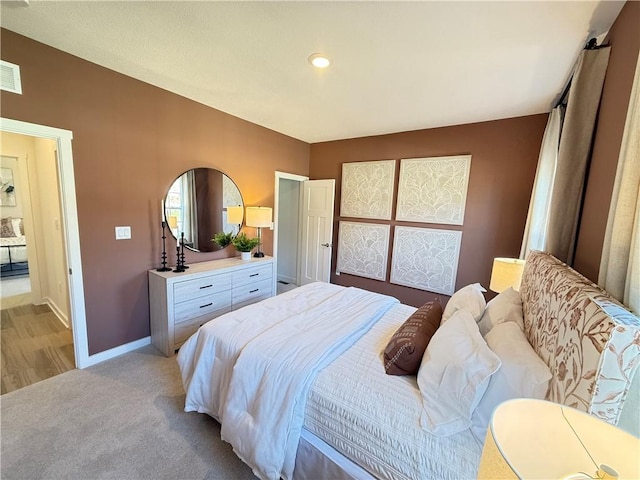 bedroom featuring light carpet