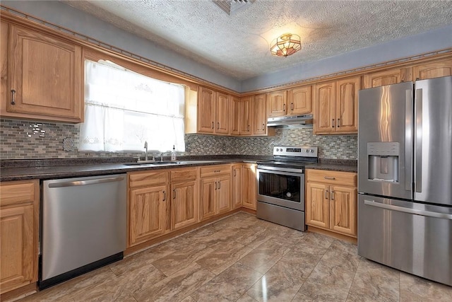 kitchen with a textured ceiling, backsplash, sink, and stainless steel appliances